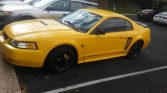 4th gen yellow 1999 Ford Mustang V6 salvage title For Sale